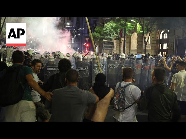 Anti-government protesters clash with riot police in Serbia during massive rally