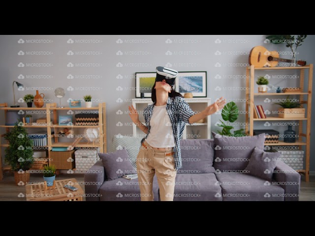 Joyful hipster having fun dancing relaxing in virtual reality glasses in house