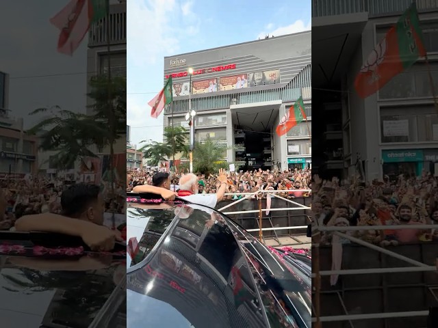 PM Modi waves to the joyful crowd during his roadshow in Ahmedabad, Gujarat