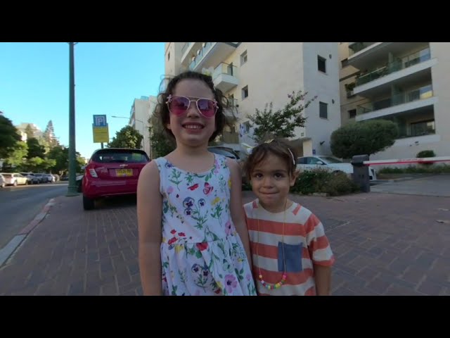 Tamar and Ariel planting at the building's Mishtala with Ofir