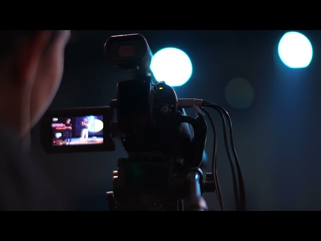 4K Free Stock Footage – Professional Cameraman Recording in Dark Studio | Cinematic Filmmaking Scene